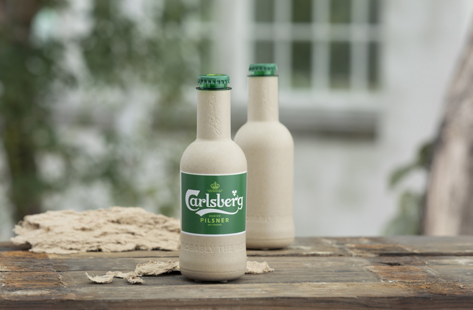 Green fibre bottle on wood surface